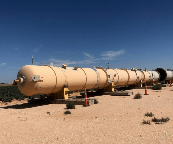 Large industrial storage and process vessels staged for recycling and resale as part of a strategic material recovery project.