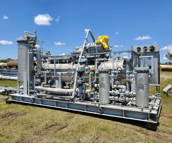 Industrial gas processing skid with pressure vessels, piping, and control systems prepared for equipment recovery and resale during decommissioning.
