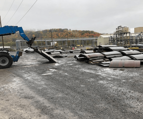 Steel plate materials being sorted and recycled as part of an industrial material recycling operation.