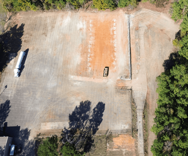 Aerial view of an industrial yard with staged vessels and equipment prepared for dismantling and material recovery